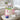 Canvas amenity tote with personal care essentials and logo placeholders on a guest suite bench