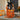 Boooo Basket, an orange willow Halloween basket with a black bow and candy, on a stone porch step