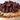 Close up of brownie pieces and chocolate ganache drizzle on top of the Brownie Cheesecake