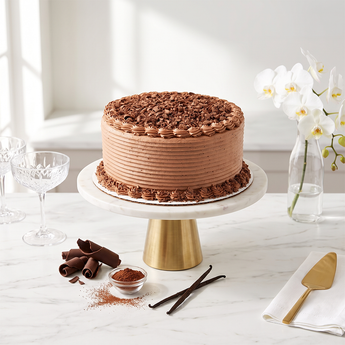 Chocolate Curls Cake with chocolate buttercream and hand-shaved chocolate curls on a cake stand