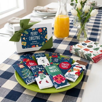 Personalized Christmas candy bar gift box with eight illustrated chocolate bars on a holiday brunch table