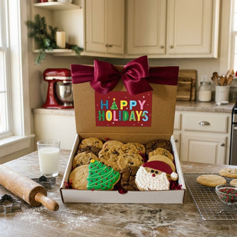 Christmas cookies and brownies gift box with iced tree and Santa cookies and a Happy Holidays card on a farmhouse kitchen table