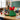 Green Christmas tree shaped box of milk chocolate holiday candy with a red bow on a teacher's desk before winter break