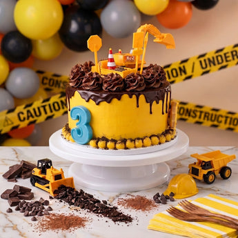 Construction Zone Cake with chocolate drip, cookie crumb dirt, construction toppers and a number 3