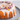 Close view of the orange glaze, sugared cranberries and orange slices on the Cranberry Orange Cake