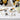 Graduation chocolate bars in custom wrappers reading Congrats Grad, Class of 2026, Just Graduated and Happy Graduation, with a gift box, on a welcome table with a guest book, white roses and black and gold balloons