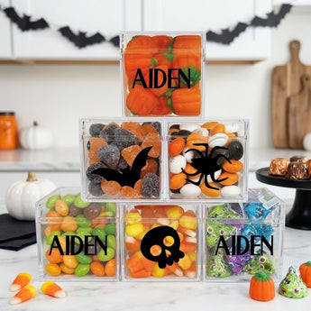 Halloween personalized candy pyramid of six clear cubes printed with a name and Halloween silhouettes on a kitchen island