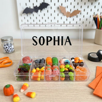 Halloween personalized candy tackle box with ten compartments of gummies and candy corn, name printed on the lid