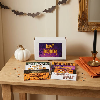 Halloween personalized chocolate bars gift box with eight printed bar wrappers fanned out on an entry table