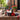Hats-off graduation gift in a navy Boston baseball cap filled with snacks, a Coca-Cola and a Congrats Grad card with a red bow, on brownstone steps with peanuts and a grad cap