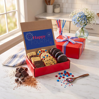 July 4th Cookies and Brownies, a red box of cookies, brownies and whoopie pies with a Happy Fourth card and a ribboned gift box, on a sunny kitchen table