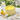 Lemon Delight Cake with lemon buttercream swirls and lemon glaze on an outdoor brunch table