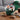 New York Jets Gift, a green Jets cap filled with snacks, chocolates, mixed nuts and soda, on a walnut coffee table on game day