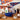 New York Mets Gift, a blue Mets cap filled with peanuts, Coca-Cola, mixed nuts and baseball chocolates, on a kitchen bar with a baseball glove
