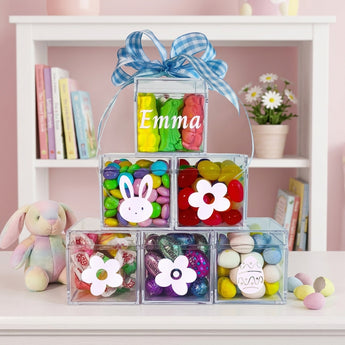 Personalized Easter Candy Pyramid, six clear cubes of pastel Easter candy with bunny stickers and a personalized name, on a child's bookshelf