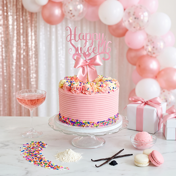 Pink Sprinkles Cake with strawberry buttercream and sprinkles at a party