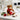 Secret Admirer Valentine's Day Gift, a brown teddy bear with a red bow holding a red gift box, on an office desk with a red rose
