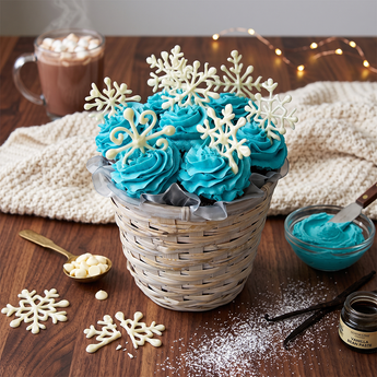 Snowflake cupcake bouquet with blue and white frosted cupcakes and sugar snowflakes in a basket