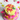 Another view of the Stars & Polka Dot Cake, a two-tier pink and yellow fondant cake with polka dots, fondant flowers and star toppers