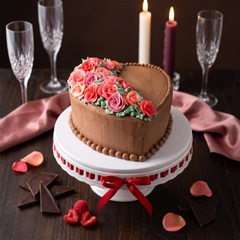 Sweetheart Rose Cake, a heart-shaped buttercream cake with soft pink and purple piped roses
