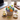 Thank you cupcake bouquet with colorful frosted cupcakes and message toppers in a woven basket on a desk