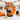 Trick or Treat Sweets in a black jack o lantern pail with an orange bow, filled with Halloween candy on a kitchen island