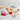 Valentine's Day Cookie Decorating Kit, heart sugar cookies with red, white and pink icing bags and sprinkles, on a marble kitchen island with cookie cutters