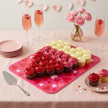 Valentine's Day Cupcake Cake, red, pink and white rosette cupcakes arranged in a heart on a pink board, on a Galentine's party dessert table with pink lemonade
