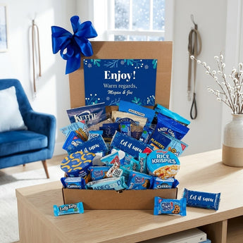Winter blue snack box with personalized card and blue bow on a living room console