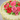 Close view of the pink and red buttercream roses on the Woven in Roses Cake