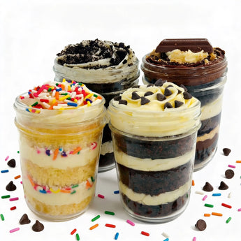 Four layered cupcake dessert jars with various toppings on a white background