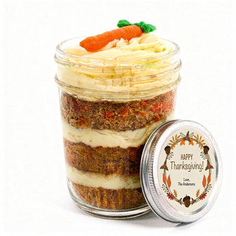 Layered carrot cupcake in a jar with a 'Happy Thanksgiving!' customizable label lid on a white background