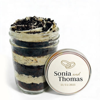 Layered cupcake dessert in a jar with personalized lid on a white background