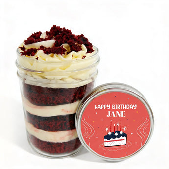Layered red velvet cupcake in a jar with a customizable 'Happy Birthday Jane' label on a white background