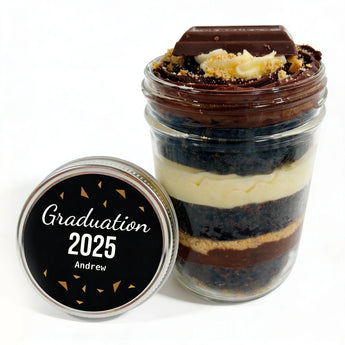 Layered cupcake dessert in a jar with a customizable graduation-themed lid on a white background
