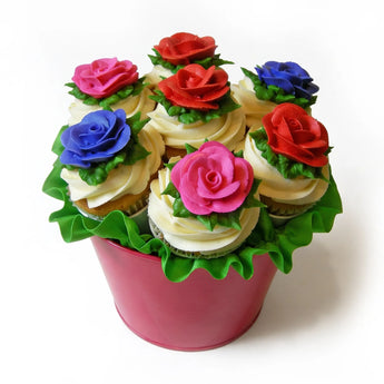 Decorative cupcake arrangement in the shape of a flower bouquet with colorful roses on a white background.