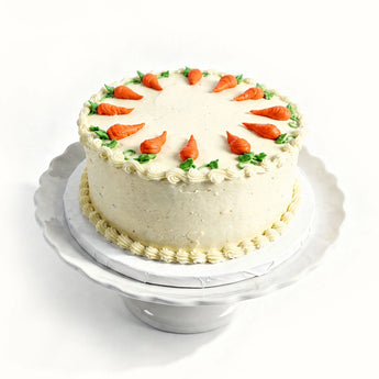 Carrot cake with decorative carrots on a white background