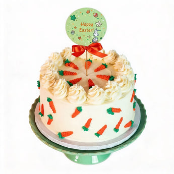 Easter cake with carrot decorations and a 'Happy Easter' sign on a white background