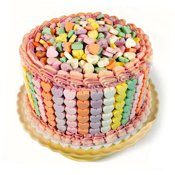 Colorful heart-shaped candy cake on a white background