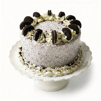 Cookies and cream cake on a white stand with a white background