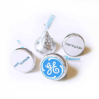 Branded Hershey's Kisses in silver foil with round sample logo labels on the bottom