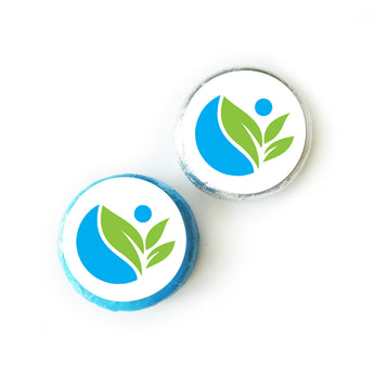 Chocolate covered Oreos wrapped in blue and silver foil with round custom logo labels