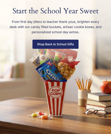 Back to school gift banner for mobile with a red and white striped popcorn bucket of candy and snacks on a teacher's desk beside books, pencils and an apple