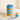 Blue Bliss cupcake jar layered with vanilla cake and blue and white buttercream topped with blue sprinkles