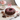 Brownie Sprinkles Cake, a chocolate bundt with chocolate glaze and pink and white sprinkles, with a personalized topper on a cake stand
