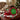 Personalized Christmas candy tin of foil wrapped chocolates with a Merry Christmas lid on a living room side table