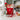 Christmas personalized baking kit with monogrammed red apron, cookie mix, spatula, whisk and cookie cutter on a white kitchen island