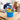 College Clean-up Bucket, a blue bucket of cleaning supplies and snacks, on a dorm room desk