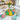 Easter Decorated Sugar Cookies, hand decorated egg shaped sugar cookies on a gold platter, on an Easter dinner table with tulips