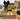 Graduation snack box with a black bow, packed with gold and yellow wrapped snacks, Class of 2026 chocolate bar and dipped Oreos, on a dorm desk among packing boxes with a grad cap